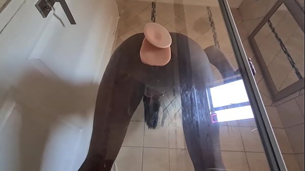 Indian slut fucking her pussy with a suction cup dildo that's stuck against glass door - 1